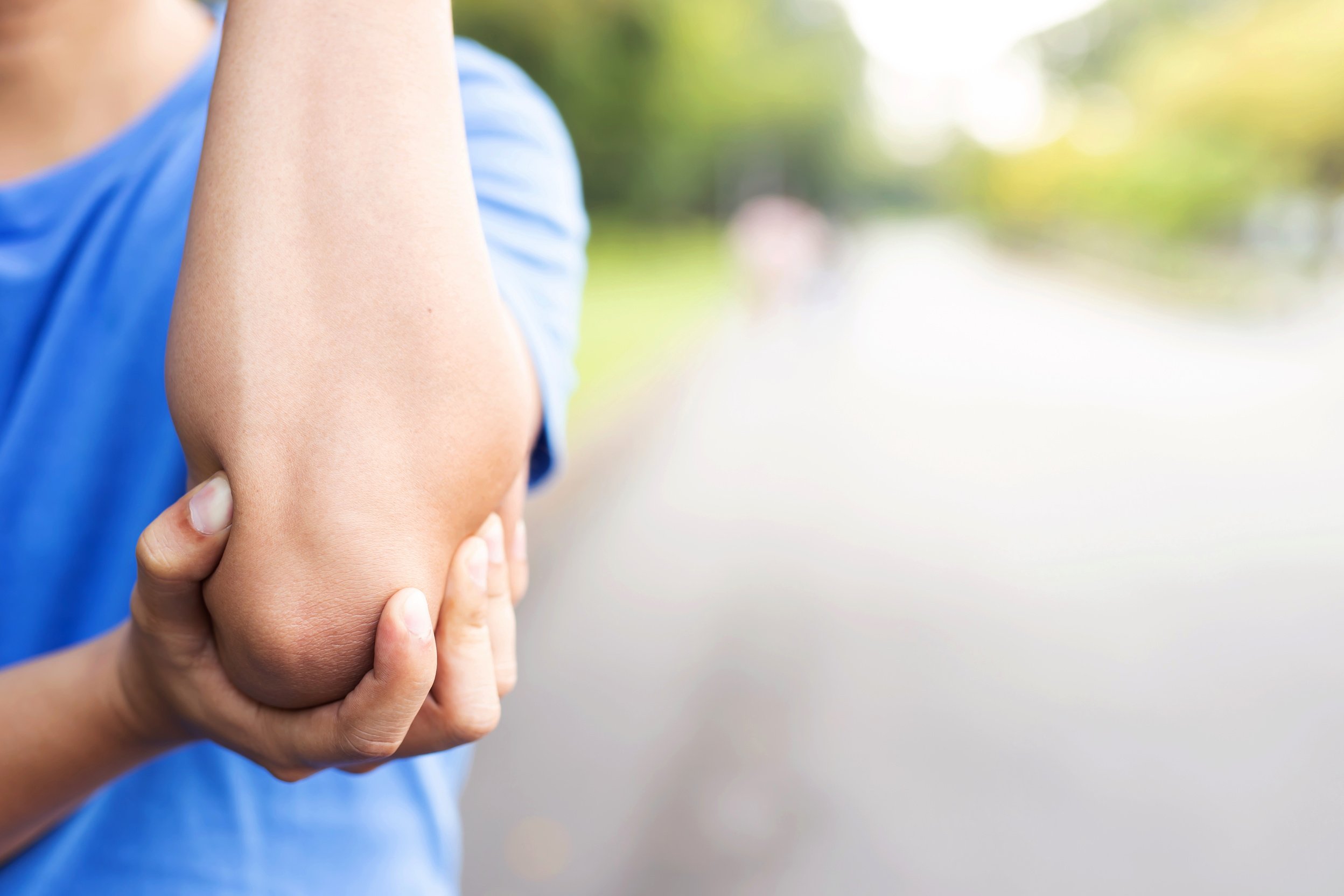 Men with elbow pain in the park